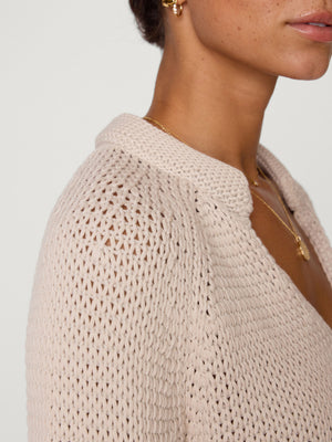 Aria stand collar deep v neckline beige sweater close up