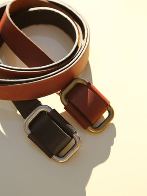 Saddle brown & black leather buckle belts close up